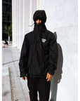 Man wearing The Stacked Jacket Black with hood up, showcasing snowboarding shell jacket for winter, waterproof and weatherproof.